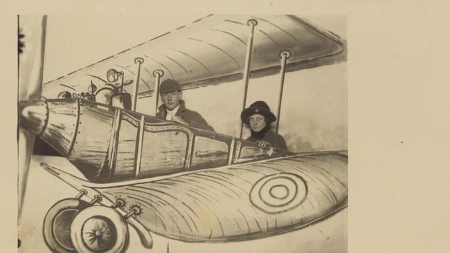 A couple poses for a picture inside an aeroplane mural in the Luna Park photographic studio, 1917-1921. Picture: Dan Clifton Collection, State Library of Victoria