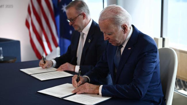 Joe Biden signs documents with Anthony Albanese during a bilateral meeting as part of the G7 Leaders’ Summit in Hiroshima.