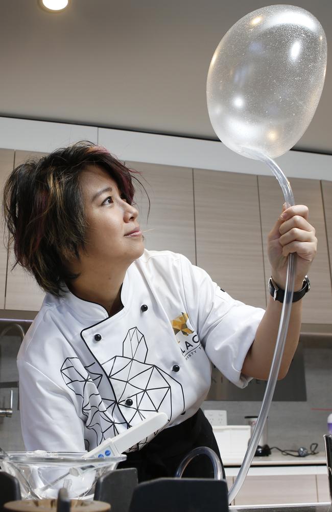 Christy from MasterChef pumps helium gas into the mixture to make the balloon. Picture: David Caird