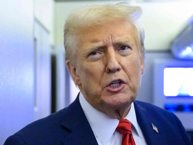 US President Donald Trump speaks to reporters while in flight on Air Force One en route Joint Base Andrews in Maryland on January 27, 2025. (Photo by Mandel NGAN / AFP)