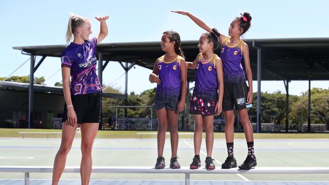 The Queensland Firebirds have held a player clinic for junior netballers at Cairns Netball following their victory over the Melbourne Vixens in Cairns on Sunday. Queensland Firebird player Rudi Ellis compares her height with Phoenix Fierce players and cousins Marutta Gulplil, 9, Nahla Moke, 8, and Mya Moke, 11. PICTURE: BRENDAN RADKE