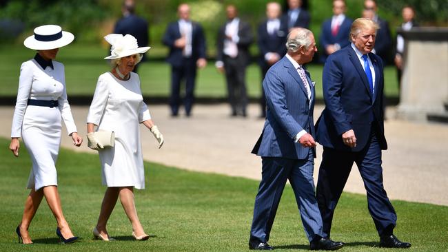 Donald and Melania Trump walk across the Buckingham Palace lawn from Marine One with Prince Charles and Camilla. Picture: Getty Images.