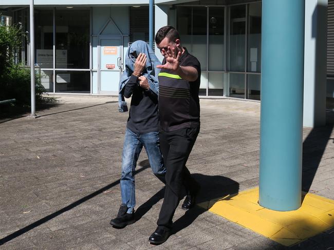 Sirens Nightclub owner Ross Glynatsis (covered) leaving court with a supporter after an earlier appearance. Picture: Richard Noone