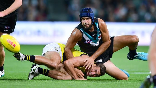 Paddy Ryder of Port Adelaide tackles Jack Higgins of the Tigers at Adelaide Oval on Saturday. Picture: Mark Brake/Getty Images