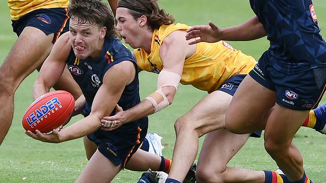 James Rowe handballs during an Adelaide Crows training session at West Lakes.