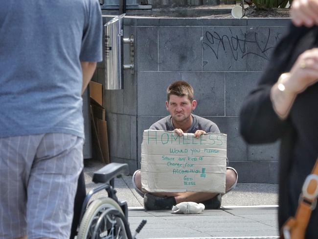 A person begging outside Flinders St station in January. Picture: Hamish Blair