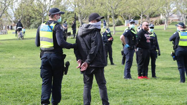 Protesters flee from all Nations Park in Northcote on Friday. Picture: NCA NewsWire / David Crosling