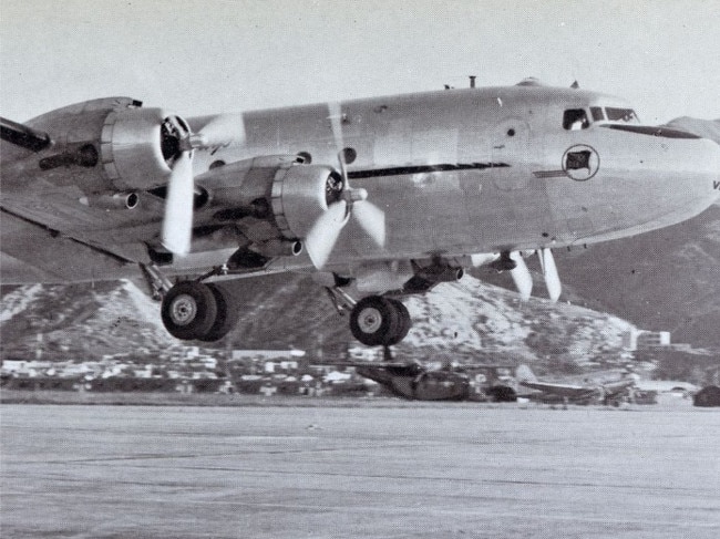 A dramatic image of a Qantas Douglas DC-4 Skymaster getting airborne from Kai Tak Airport, Hong Kong shortly after Qantas began flying there in 1949.