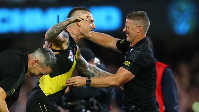 Dustin Martin celebrates with coach Damien Hardwick at the Gabba. Picture: Getty Images