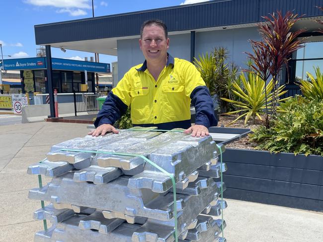 Gladstone Mayor Matt Burnett behind a stack of aluminum ingots at the Rio Tinto Boyne smelter.