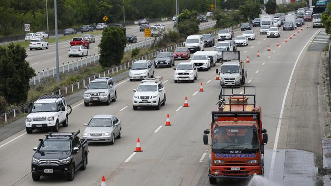 Slow moving traffic along the M1 near Oxenford on Gold Coast on Saturday following flash flooding. Picture: AAP Image/Regi Varghese