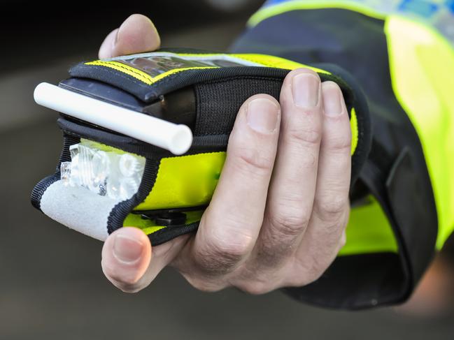 Belfast, Northern Ireland. 24 Nov 2016 - A police officer holds a roadside breathalyser alcohol breath test after taking a sample from a driver.