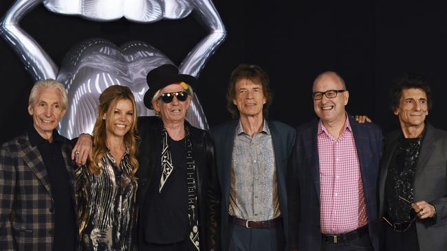 The Rolling Stones pose during a preview of 'The Rolling Stones: Exhibitionism' in London in 2016 with Tony and Thea Cochrane