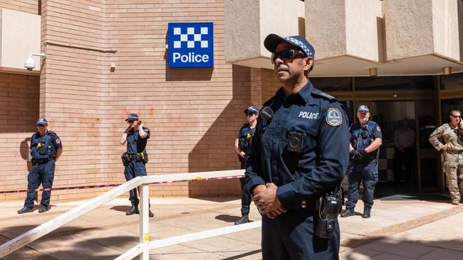 Police stand by outside the Alice Springs police station as rallying protesters gathered on Thursday. Picture: Emma Murray