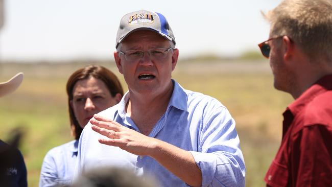 15/2/2019: PM Scott Morrison holds a press conference on the main road after he inspected the twisted and destroyed main railway line running between Mount Isa and Townsville with local mayors, which is surrounded by the rotting carcasses of dead cattle  after floods sweep through the area earlier this week,  just east of Julia Creek about 3 hrs east of Mount Isa. The railway line may be unusable for some time, with a huge amount of repair work to be done . Lyndon Mechielsen/The Australian