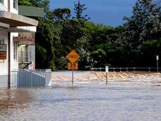 Water spilling over the levee wall at Molesworth Street. Picture: Cathy Adams