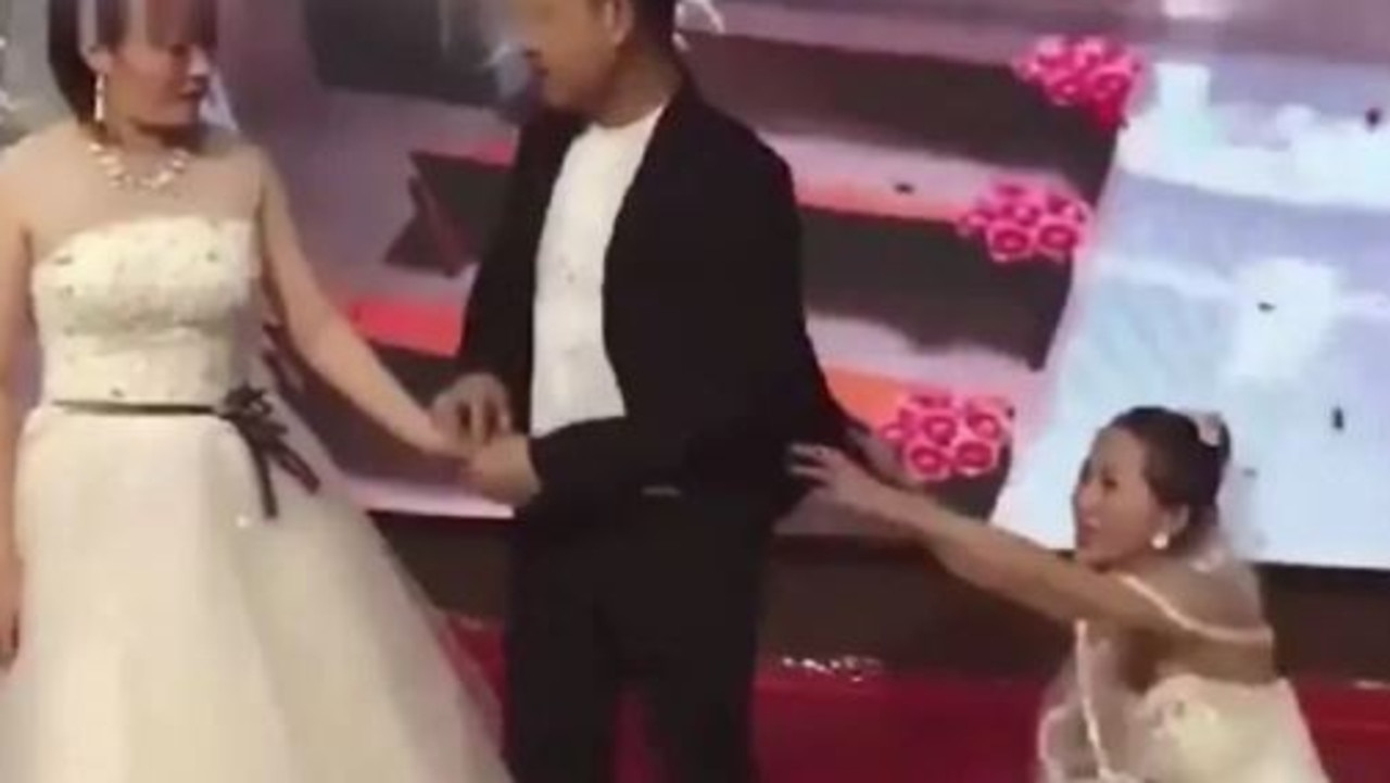 A similar situation happened in China, where this time a woman dressed as a bride on her ex-boyfriend’s wedding day, begging for him back as he was about to tie the knot. Picture: Sina News