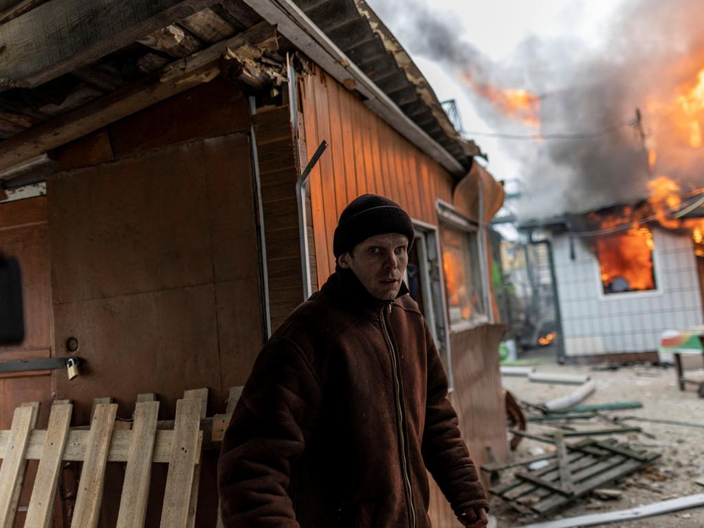 A local resident reacts as a house is on fire after heavy shelling on the only escape route used by locals to leave the town of Irpin, while Russian troops advance towards the capital, 24km from Kyiv, Ukraine March 6, 2022. Reuters/Carlos Barria