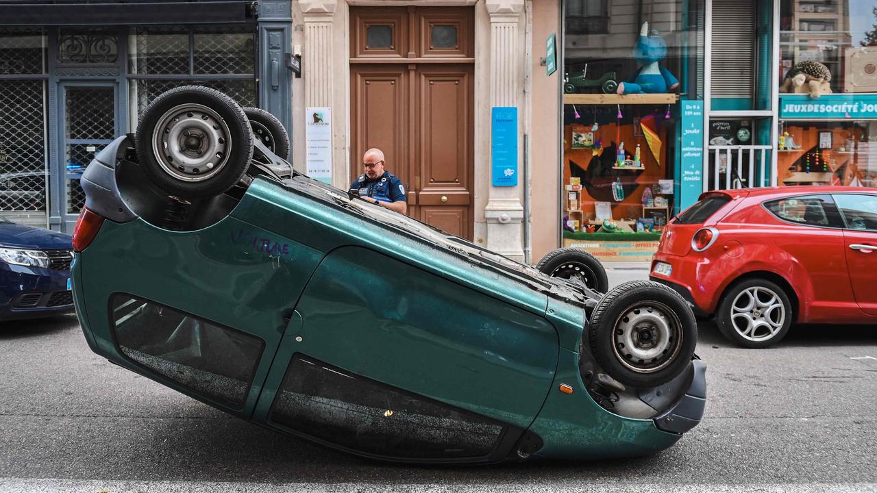 Rioters are setting fires, looting and flipping cars. Picture: Olivier Chassignole / AFP