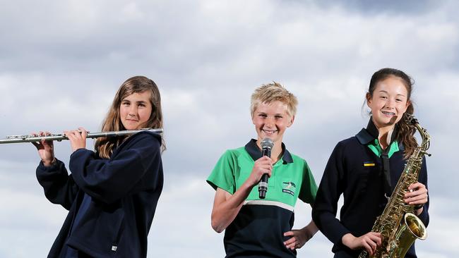 Grade 6 musicians Zoe Gangell, form Cambridge Primary School, left, emcee Kelby Miley – who will also be playing trumpet – and Mei Booker, from Bellerive Primary School, get ready for the annual combine primary schools band and choir concert. Picture: RICHARD JUPE