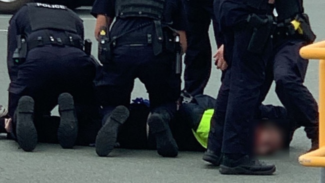 Arrest at Harbour Town shopping centre (pixelated). Photo: Kathleen Skene