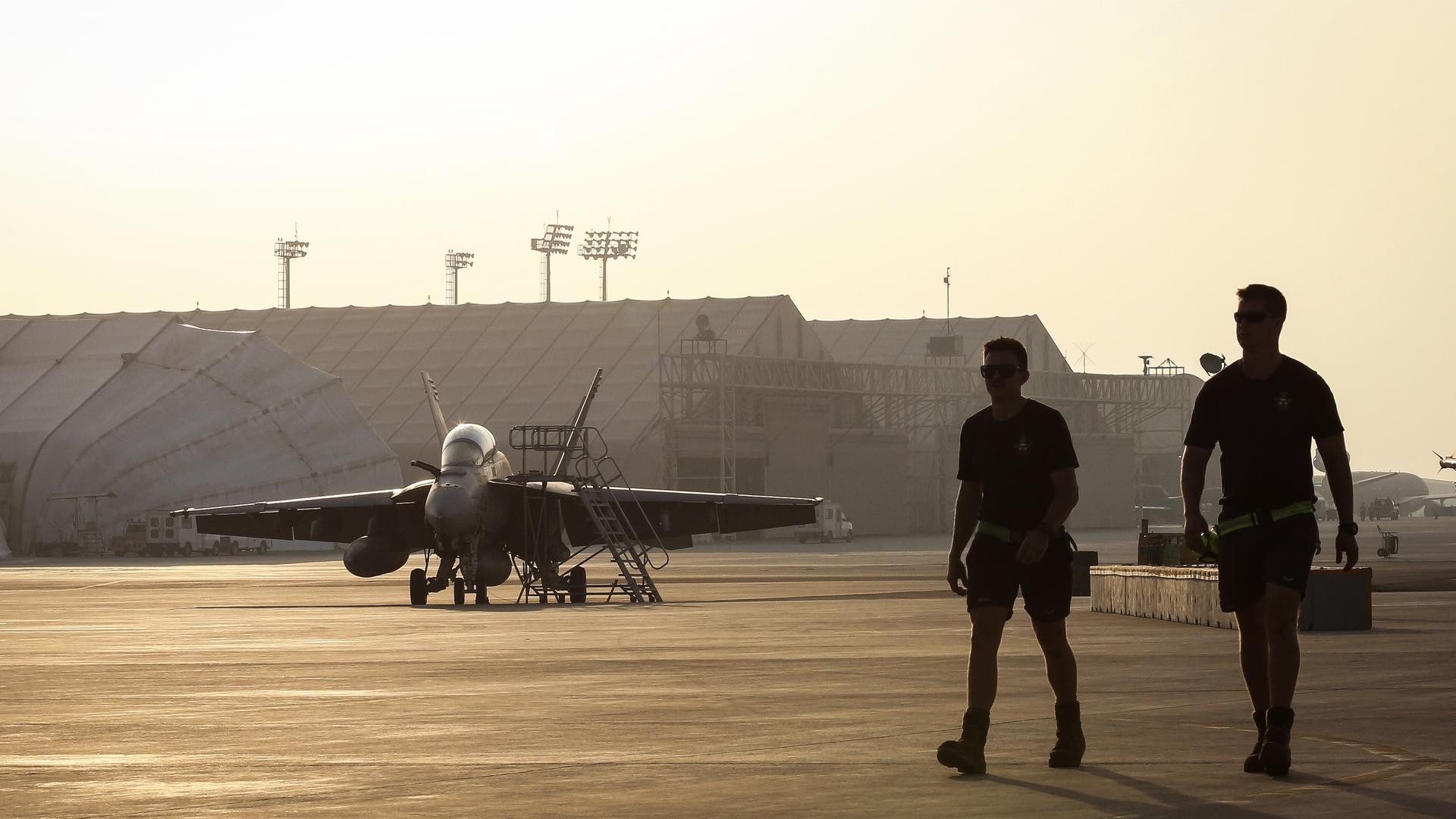 Royal Australian Air Force ground staff members walk back to their hanger after attending to F/A-18F Super Hornet aircraft on the main air operating base in the Middle East Region ahead of their next Operation Okra mission. *** Local Caption *** Maintainers deployed at part of the Air Task Group on Operation OKRA perform a Foreign Object Debris (FOD) walk as part of the morning procedures at the main air operating base in the Middle East Region. The Air Task Group (ATG) is deployed as part of Operation OKRA and is operating at the request of the Iraqi Government within a US-led Global Coalition assembled to degrade and defeat Daesh. The ATG comprises six RAAF F/A-18F Super Hornet fighter aircraft, an E-7A Wedgetail airborne command and control aircraft, and a KC-30A Multi Role Tanker Transport aircraft. Additionally, the ATG has personnel working in the Combined Air and Space Operations Centre, and embedded with the ‘Kingpin’ US tactical Command and Control Unit.