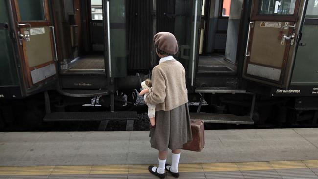 A girl re-enacting a scene from 70 years ago, stands in front of the Winton train before its departure from Prague to London on September 1, 2009. The historical train departed from Prague to re-trace the original route from Prague to London with several survivors and descendants of 669 so-called Winton's children on board.