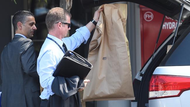 Detectives collect evidence bags. Picture: Nicole Garmston