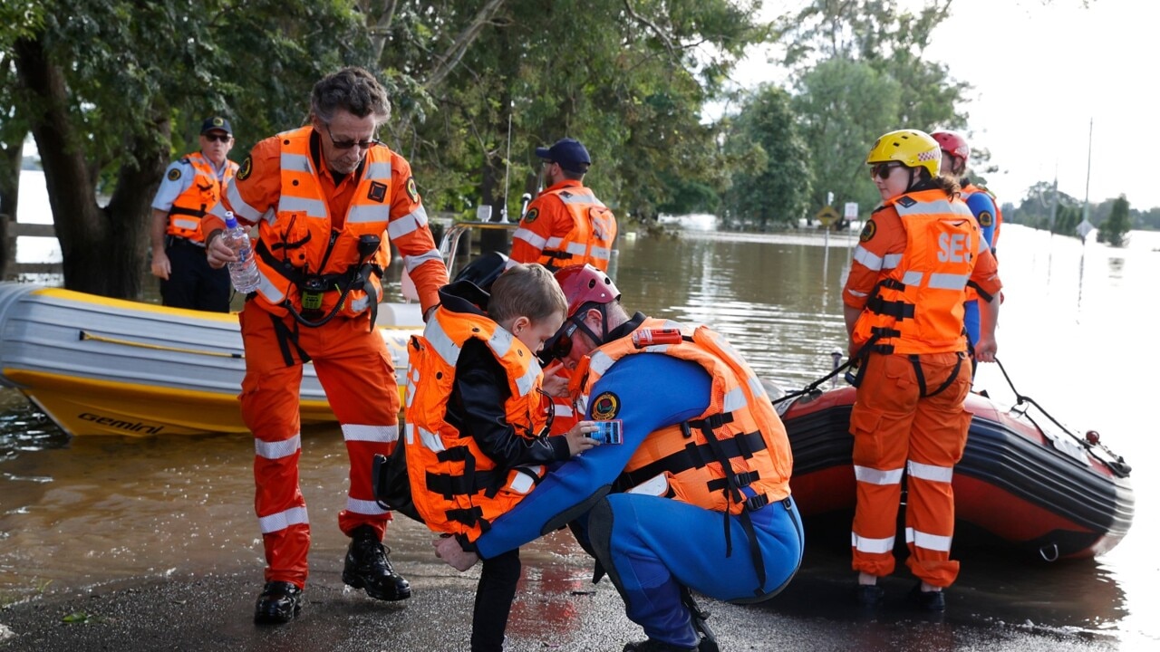 Emergency services ferry people and supplies to areas still cut off by floodwater