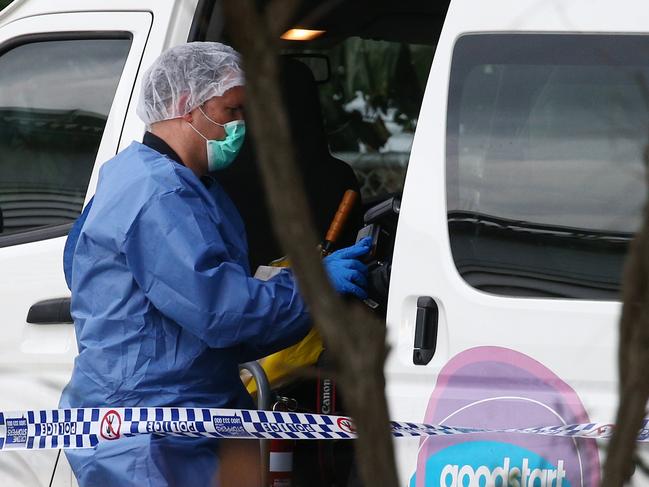 Police officers attend Hambledon State School at Edmonton, where a 3 year old was found dead in a Goodstart Early Learning Centre minibus at around 3:30pm on Tuesday. A police forensic officer inspects the van. PICTURE: BRENDAN RADKE