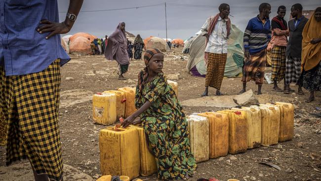 BAIDOA, SOMALIA - SEPTEMBER 3: A girl sits on water bottles in a displacement camp for people impacted by drought on September 3, 2022 in Baidoa, Somalia. Extreme drought has destroyed crops and seen a hike in food prices, leaving 7 million people (out of a total population of 16 million) at risk of famine in Somalia. (Photo by Ed Ram/Getty Images)