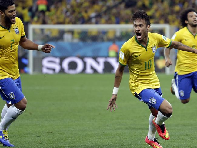 Brazil's Neymar, centre, celebrates after scoring his sides first goal during the group A World Cup soccer match between Brazil and Croatia, the opening game of the tournament, in the Itaquerao Stadium in Sao Paulo, Brazil, Thursday, June 12, 2014. (AP Photo/Felipe Dana)