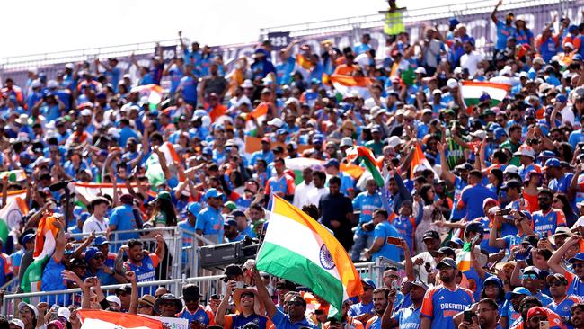 India fans celebrate in the stands following the team's victory. Photo by ROBERT CIANFLONE / GETTY IMAGES.