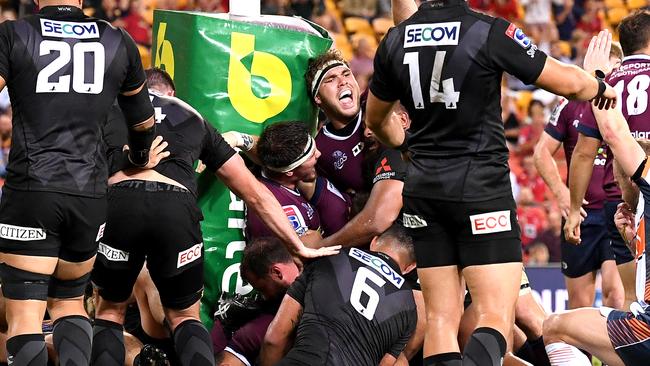 Angus Scott-Young of the Reds celebrates a try by team mate Brandon Paenga-Amosa on Friday night. Picture: Getty Images 