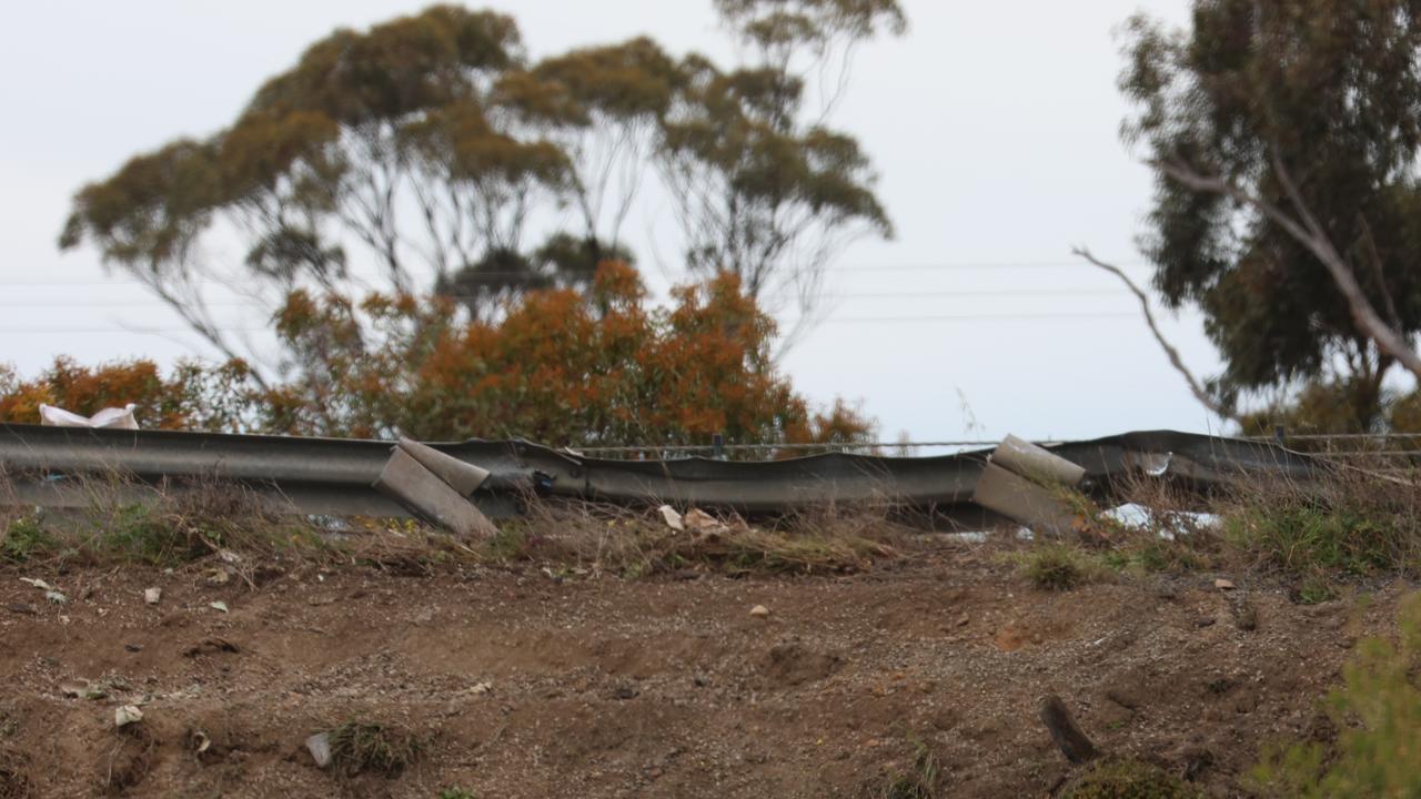 The bus broke through the road barrier and crashed down the embankment. Picture: Brendan Beckett