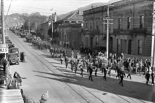 A parade marching along Macquarie Street .
