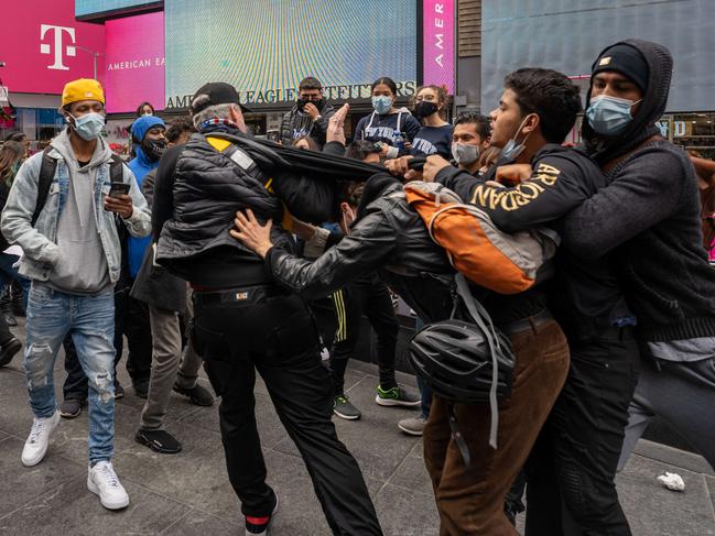 NEW YORK, NY - OCTOBER 25: Trump supporters and Trump protesters get into a physical altercation at a rally and march for President Donald Trump at Times Square on October 25, 2020 in New York City. As the November 3rd presidential election nears, Trump supporters and protestors have taken to the streets to be heard.   David Dee Delgado/Getty Images/AFP == FOR NEWSPAPERS, INTERNET, TELCOS & TELEVISION USE ONLY ==