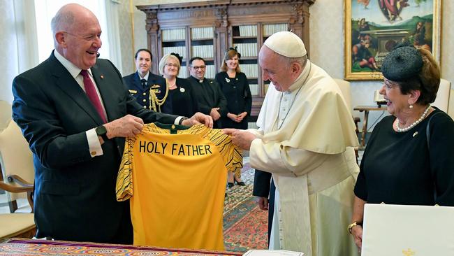 Pope Francis, centre, exchanges gifts with Australian Governor General Peter Cosgrove and his wife Lynne Cosgrove. Picture: AFP