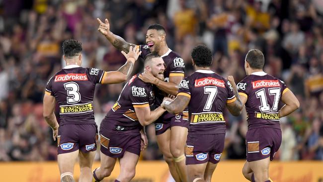 The Broncos celebrate after Kurt Capwell kicked a field goal to seal the victory. Picture: NRL Images.