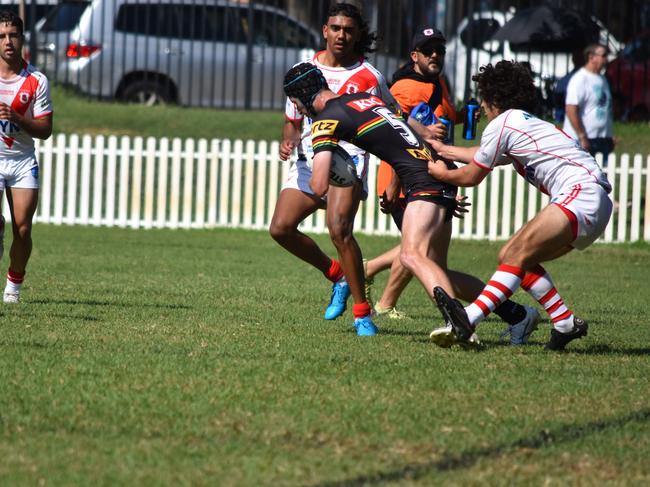 Jacob Kelly is tackled by Omar Dennaoui. Picture: Sean Teuma/NewsLocal