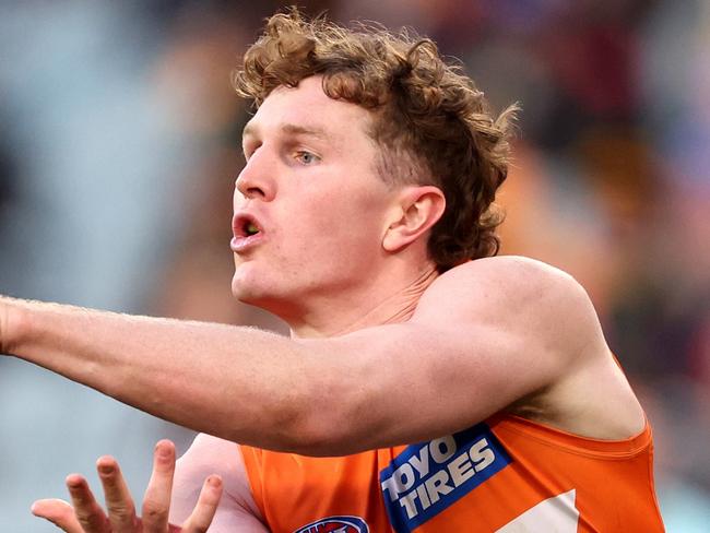 MELBOURNE, AUSTRALIA - JULY 14: Tom Green of the Giants handballs during the round 18 AFL match between Richmond Tigers and Greater Western Sydney Giants at Melbourne Cricket Ground, on July 14, 2024, in Melbourne, Australia. (Photo by Robert Cianflone/Getty Images)