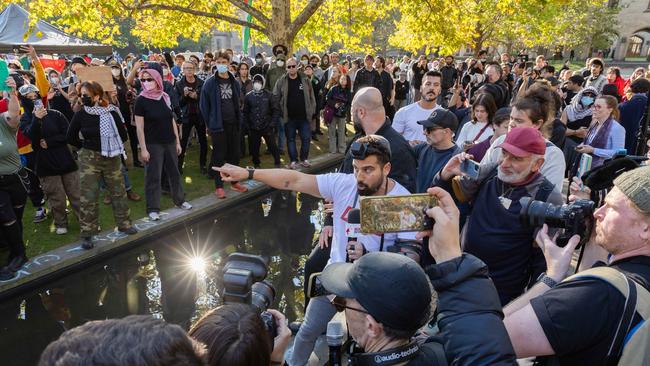 A woman grabs the mic of controversial news figure Avi Yemeni. Picture: Jason Edwards