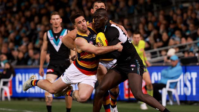 Lachie Murphy tackles Aliir Aliir during a hot opening term of Showdown 52. Picture: James Elsby/AFL Photos