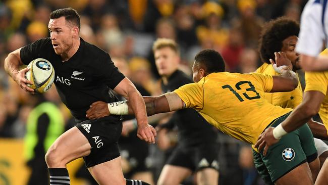 Ryan Crotty of New Zealand escapes a tackle by Samu Kerevi of Australia on Saturday night.