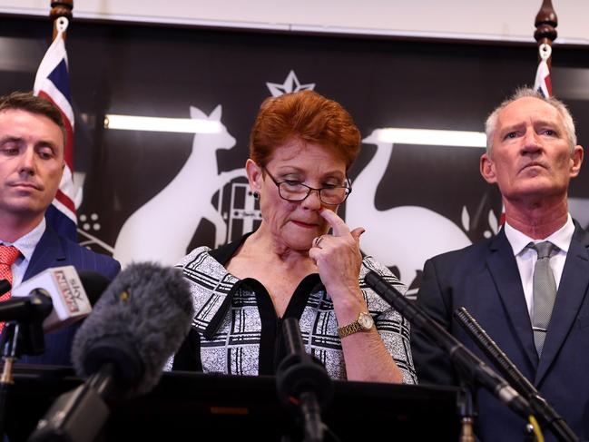 Queensland Senator and One Nation leader Pauline Hanson (centre), flanked by party officials James Ashby (left) and Steve Dickson, speaks during a press conference in Brisbane, Thursday, March 28, 2019. Mr Ashby and Mr Dickson were caught in an al-Jazeera investigation which used hidden cameras and a journalist posing as a gun campaigner to expose the far-right party's extraordinary efforts to obtain funding in Washington DC in September. (AAP Image/Dan Peled) NO ARCHIVING