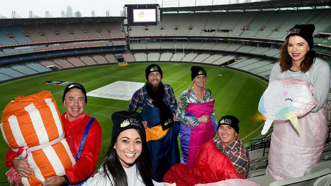 Left to right: Mark Anderson, Natasha Crooks, Morgan Slocombe, Astrid Blackburn, Stuart Fox, and Jo Fisher rug up ahead of Thursday night’s Sleep at the ‘G annual fundraiser. Picture: Nicole Garmston