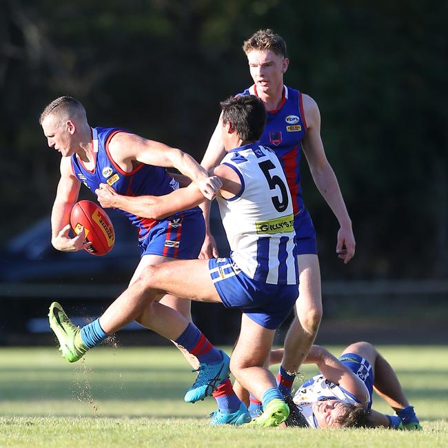 Beechworth’s Brayden Carey tries to break clear of a tackle from Yackandandah’s Ben McIntosh.