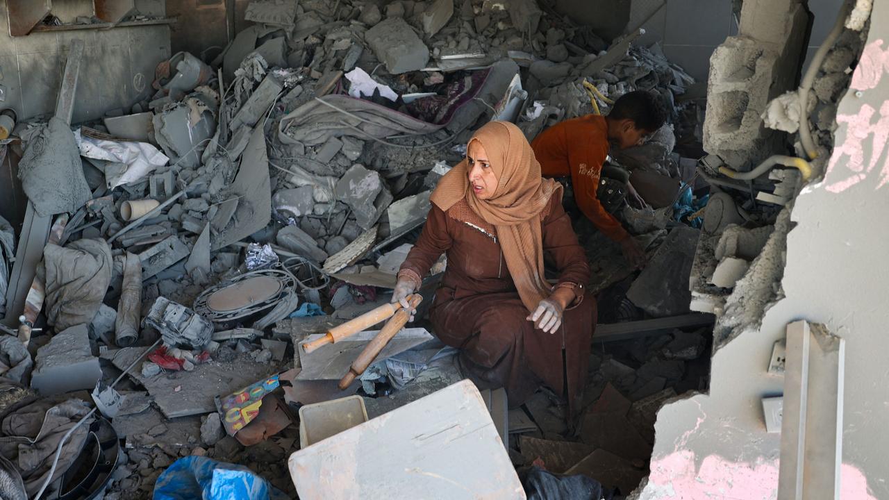 A Palestinian woman salvages belongings from the rubble of a house hit by overnight Israeli bombing in Rafah in the southern Gaza Strip on April 20, 2024, amid the ongoing conflict between Israel and the Hamas movement. (Photo by AFP)