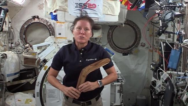 Dr Walker on board the ISS with a boomerang made by Kaurna man Jack Buckskin.