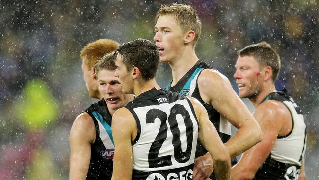 Power players celebrate with Todd Marshall after a goal against West Coast. Picture: Will Russell/AFL Photos/Getty Images